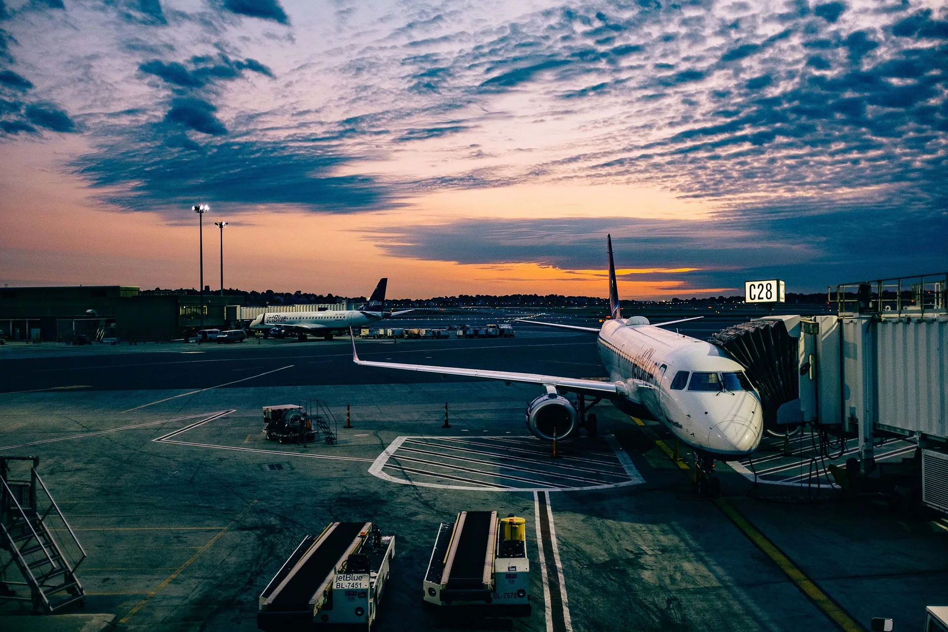 Aircraft and ground crew on an airport stand.